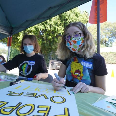 Two people making signs. 