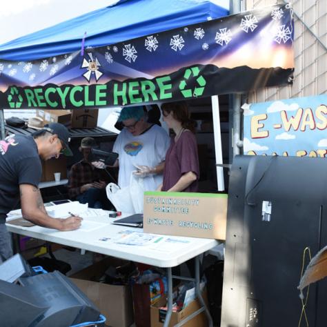 People shopping at yard sale.