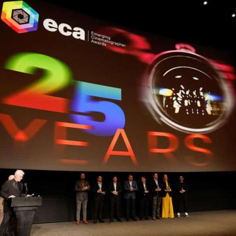 Projection on stage with '25 Years' written. 