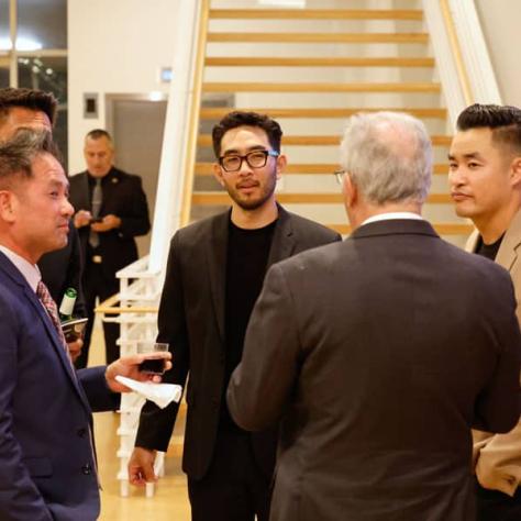 People talking together at event. 