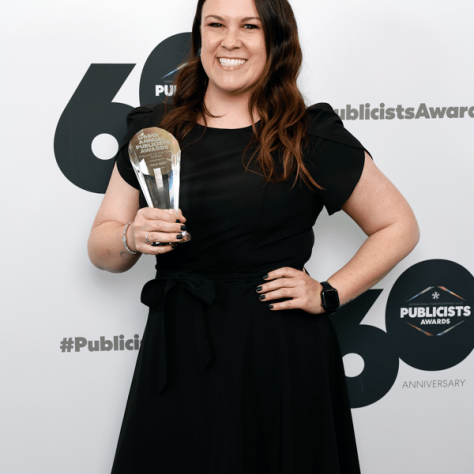 Woman posing with award. 
