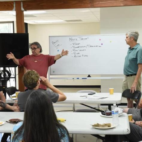 People presenting to audience. 