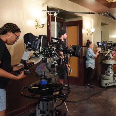 Woman working behind a camera. 