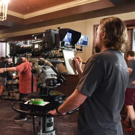 Man working behind a camera. 