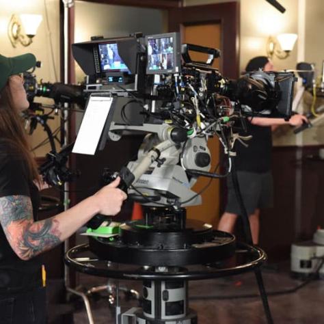 Woman working behind a camera. 