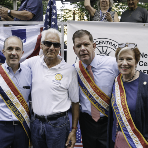 People posing for a photo wearing sashes. 