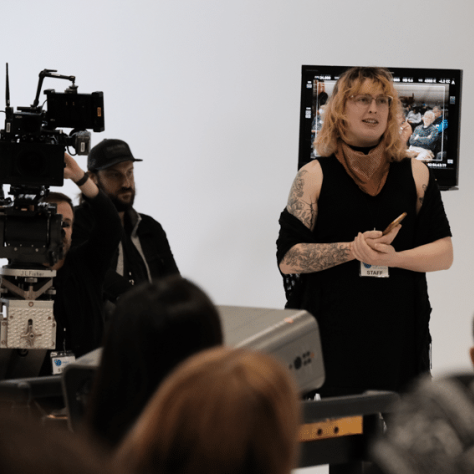 Woman standing in front of audience. 