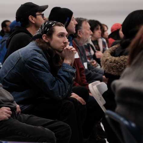 Audience members watching something. 