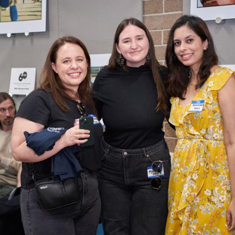 People posing for photo together at party.