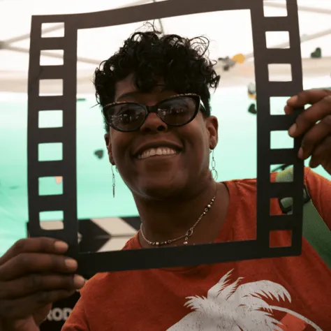 Woman taking a photo in a film frame. 