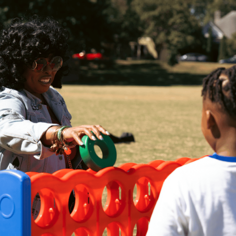 People playing large connect four. 