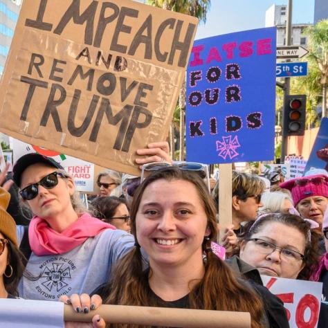 People marching while holding signs