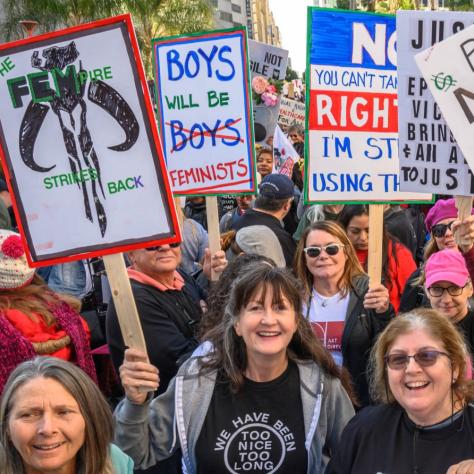 People marching while holding signs