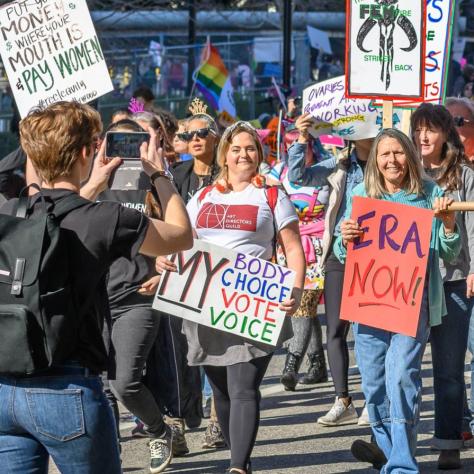 People marching while holding signs