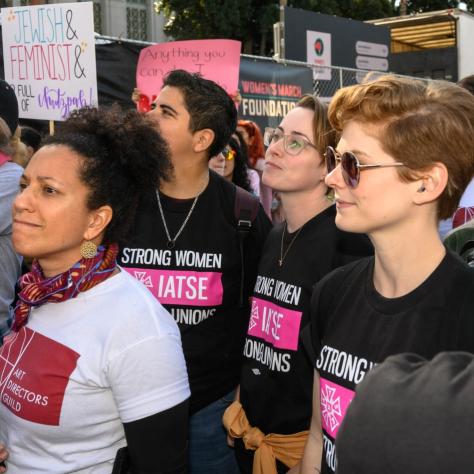 People marching while holding signs