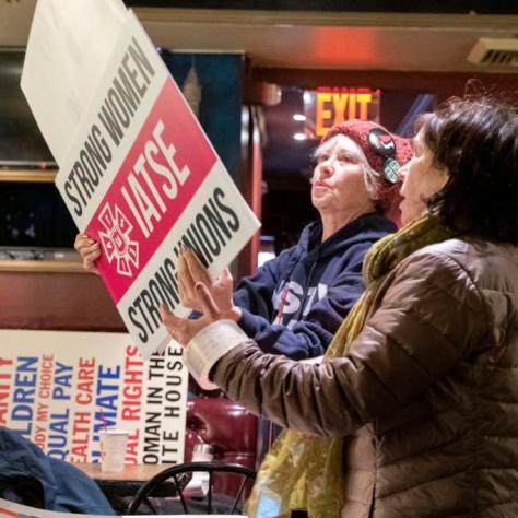 Women inspecting signs