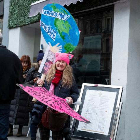 Woman holding two signs