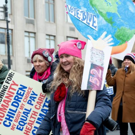 Women holding signs and marching