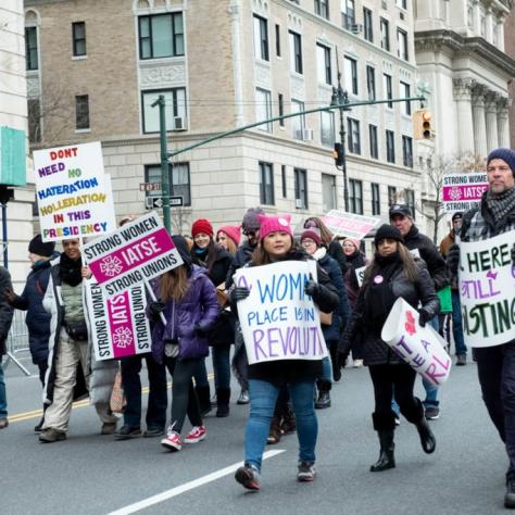 People marching while carrying signs