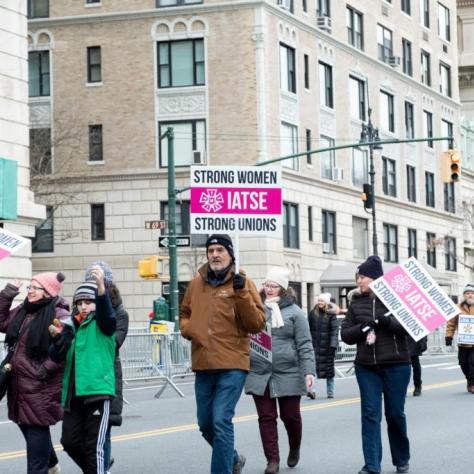 People marching while holding signs