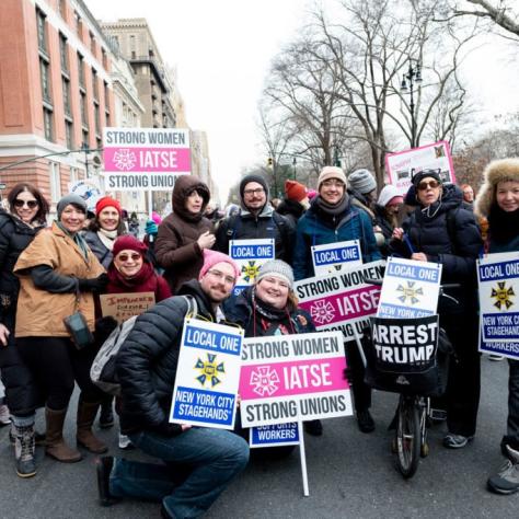People holding signs and posing for a photo