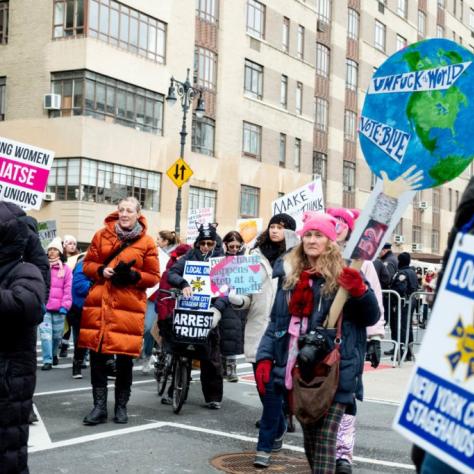 People marching while holding signs