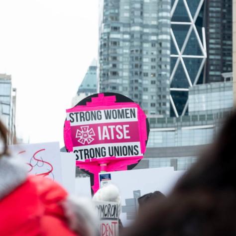 Sign that reads "STRONG WOMEN STRONG UNIONS IATSE"