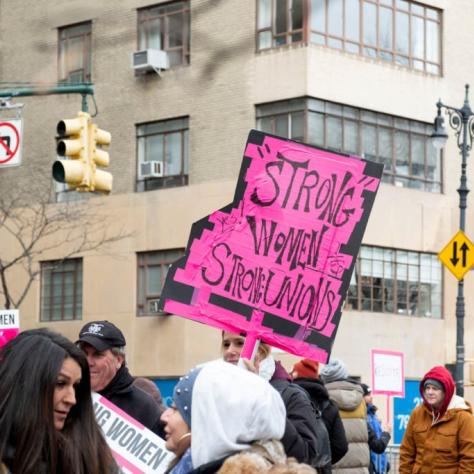 Sign that reads "STRONG WOMEN STRONG UNIONS"