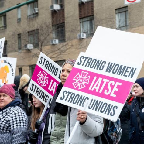 People marching while holding signs