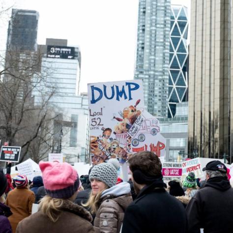 People marching while holding signs