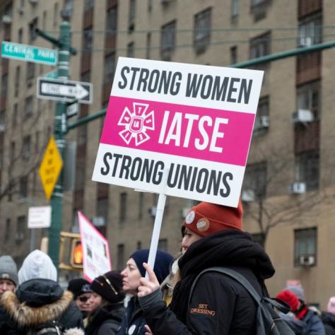 Sign that reads "STRONG WOMEN STRONG UNIONS IATSE"