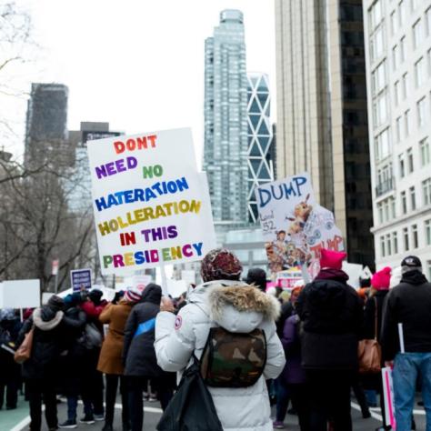 People marching while holding signs