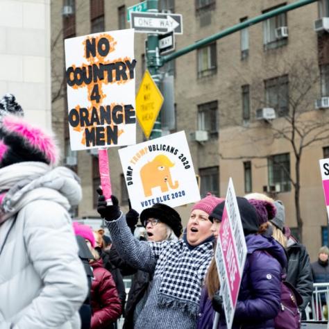People marching while holding signs