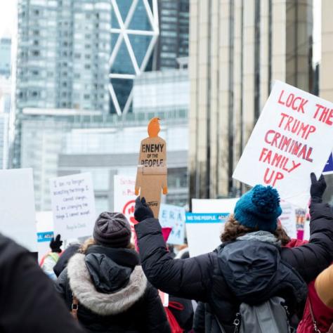People marching while holding signs