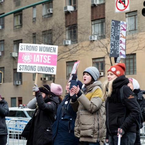 People marching while holding signs