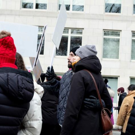 People marching while holding signs