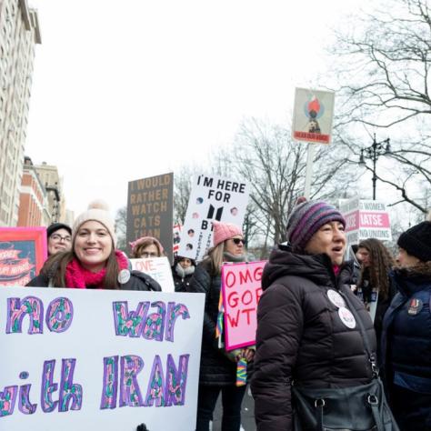 People marching while holding signs