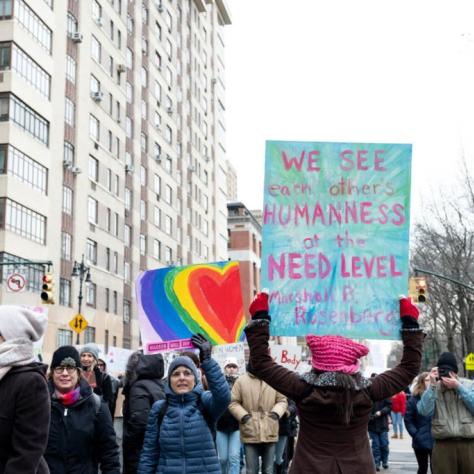 People marching while holding signs