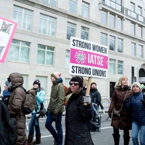 People marching while holding signs
