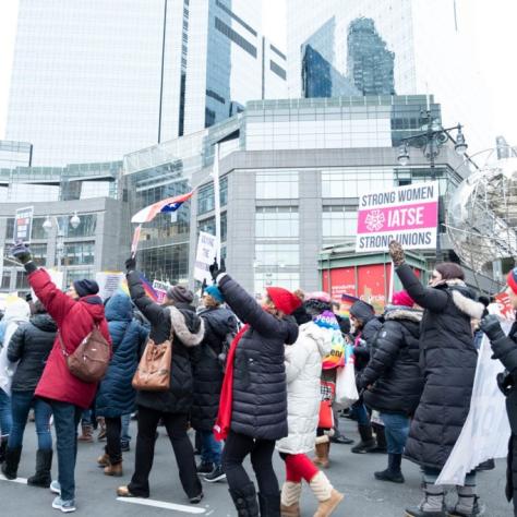 People marching while holding signs