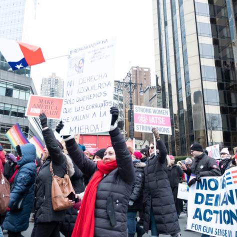 People marching while holding signs