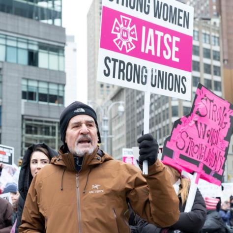 People marching while holding signs