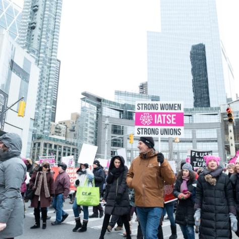 People marching while holding signs