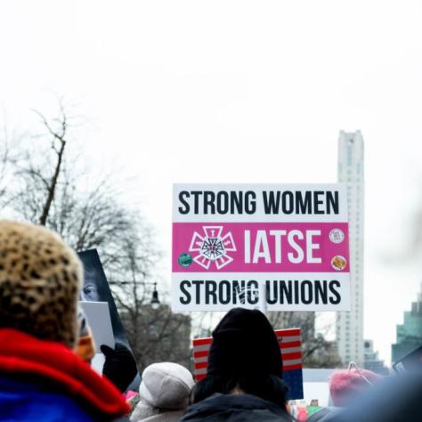 People marching while holding signs