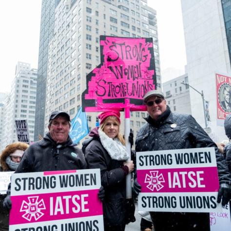 People marching while holding signs