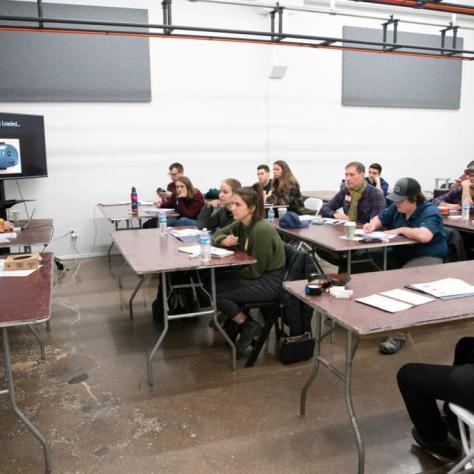 A classroom full of students sitting at tables