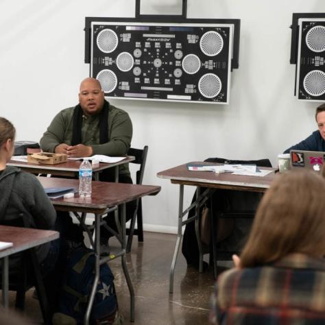 Students seated at tables casually chatting