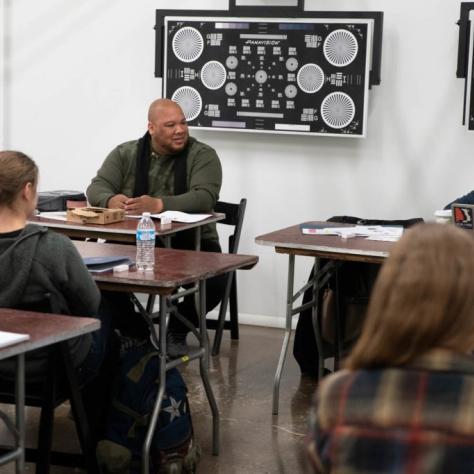 Students seated at tables casually chatting