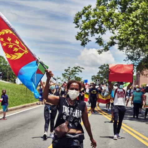 Woman holding flag while marching in BLM protest