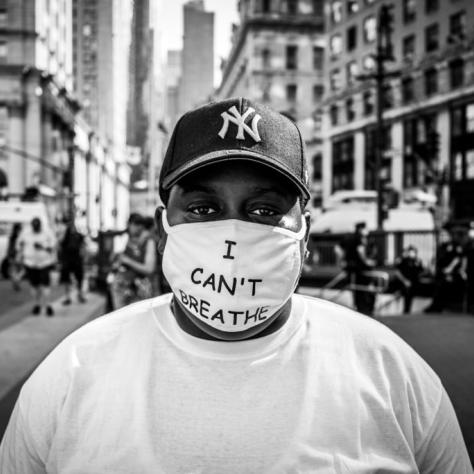 Man wearing a mouth covering that reads "I CAN'T BREATHE"